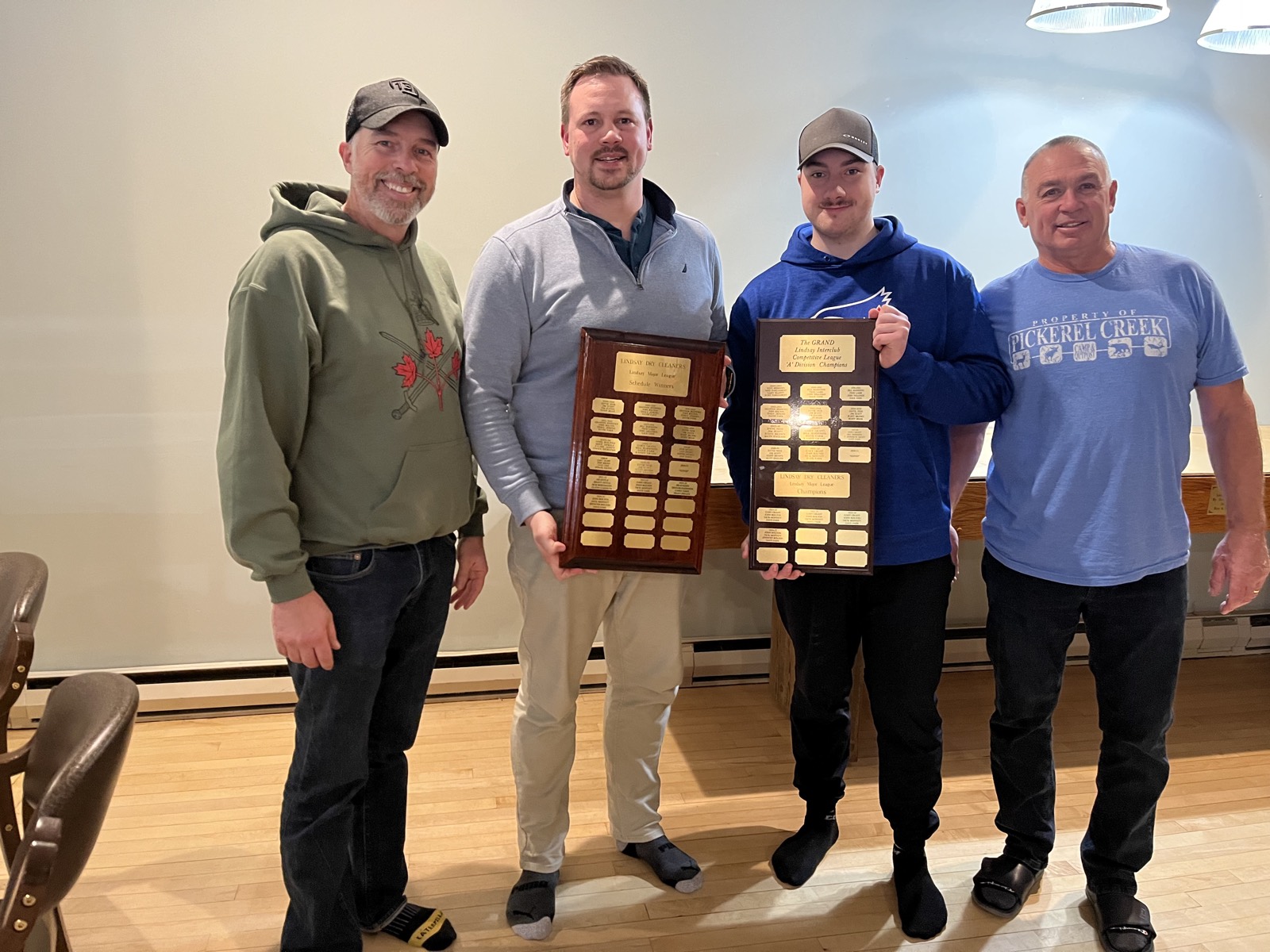 Team Bolton with the Major League schedule and A Division trophies